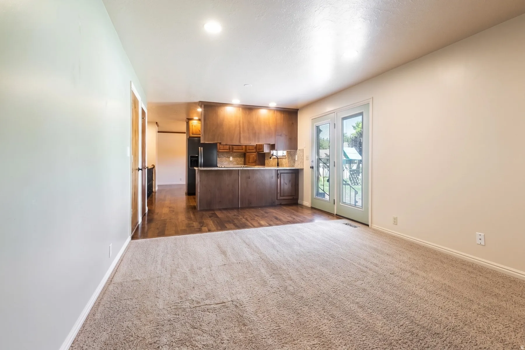 Open-concept living space that open to flat back yard.