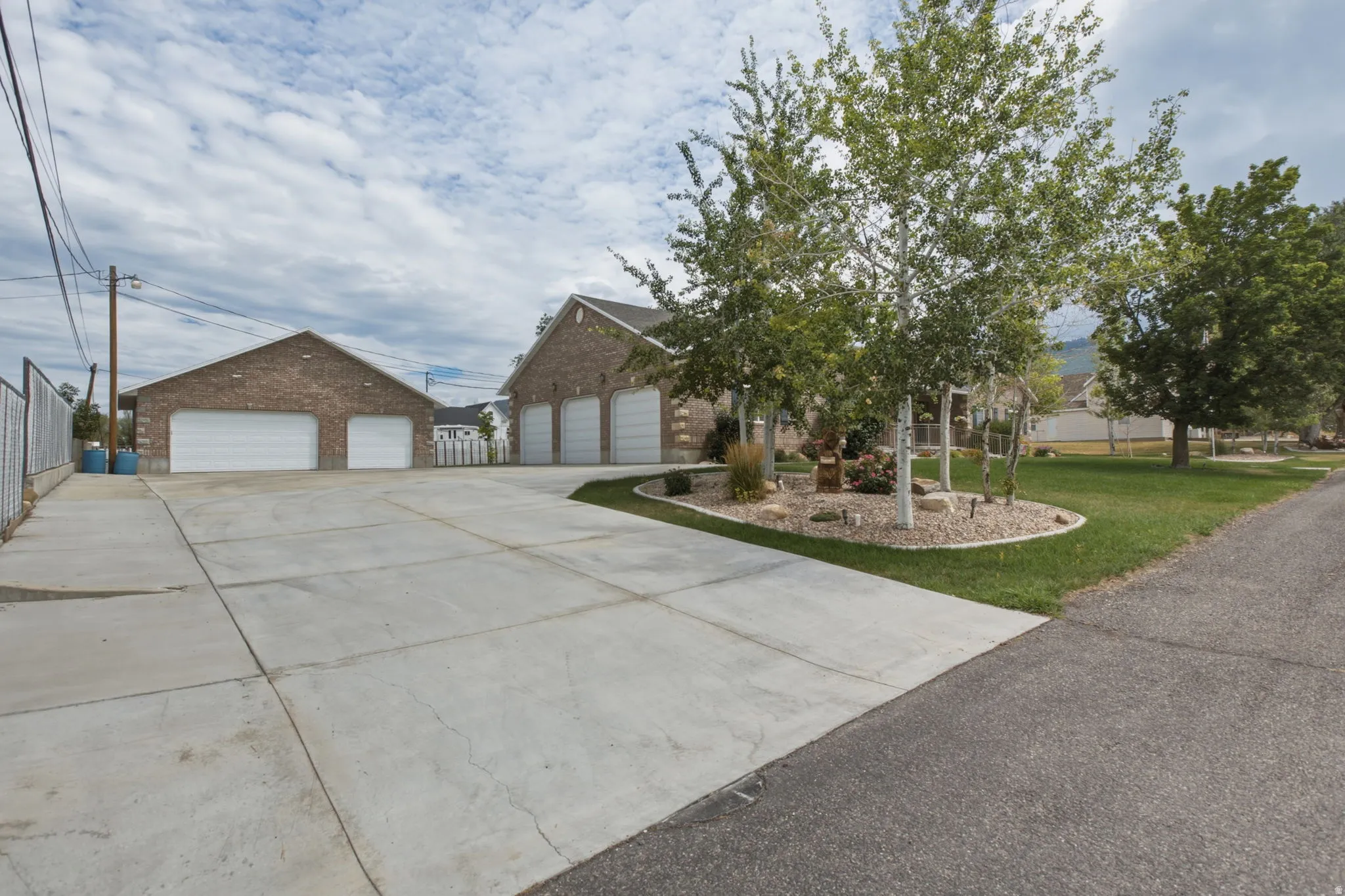 Extensive concrete driveway providing access to two brick structures