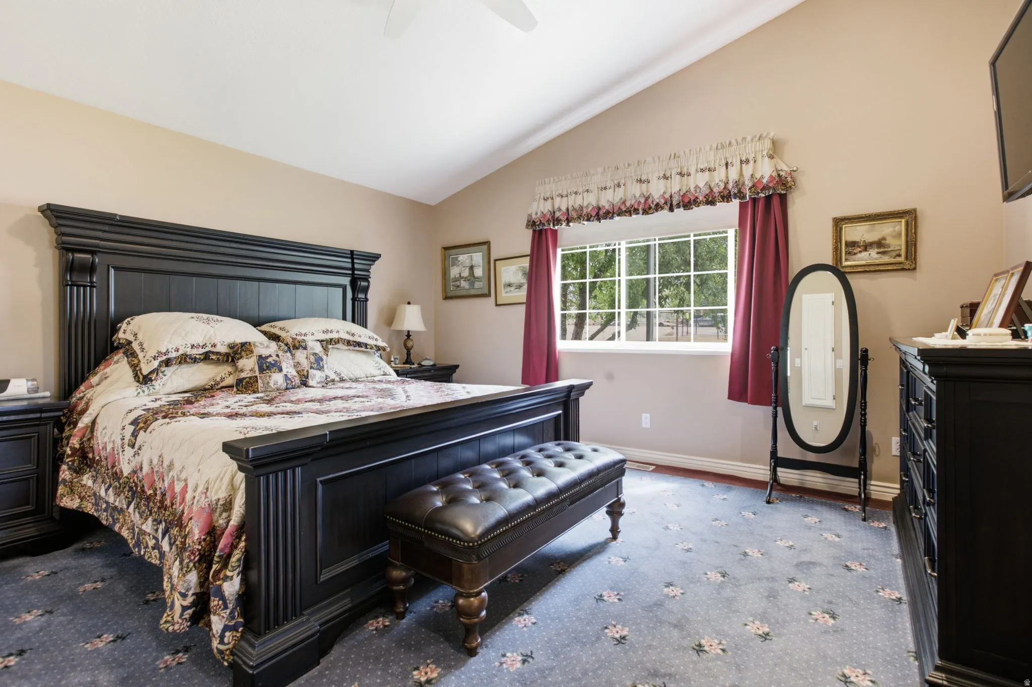 Vaulted ceilings enhance this bedroom space