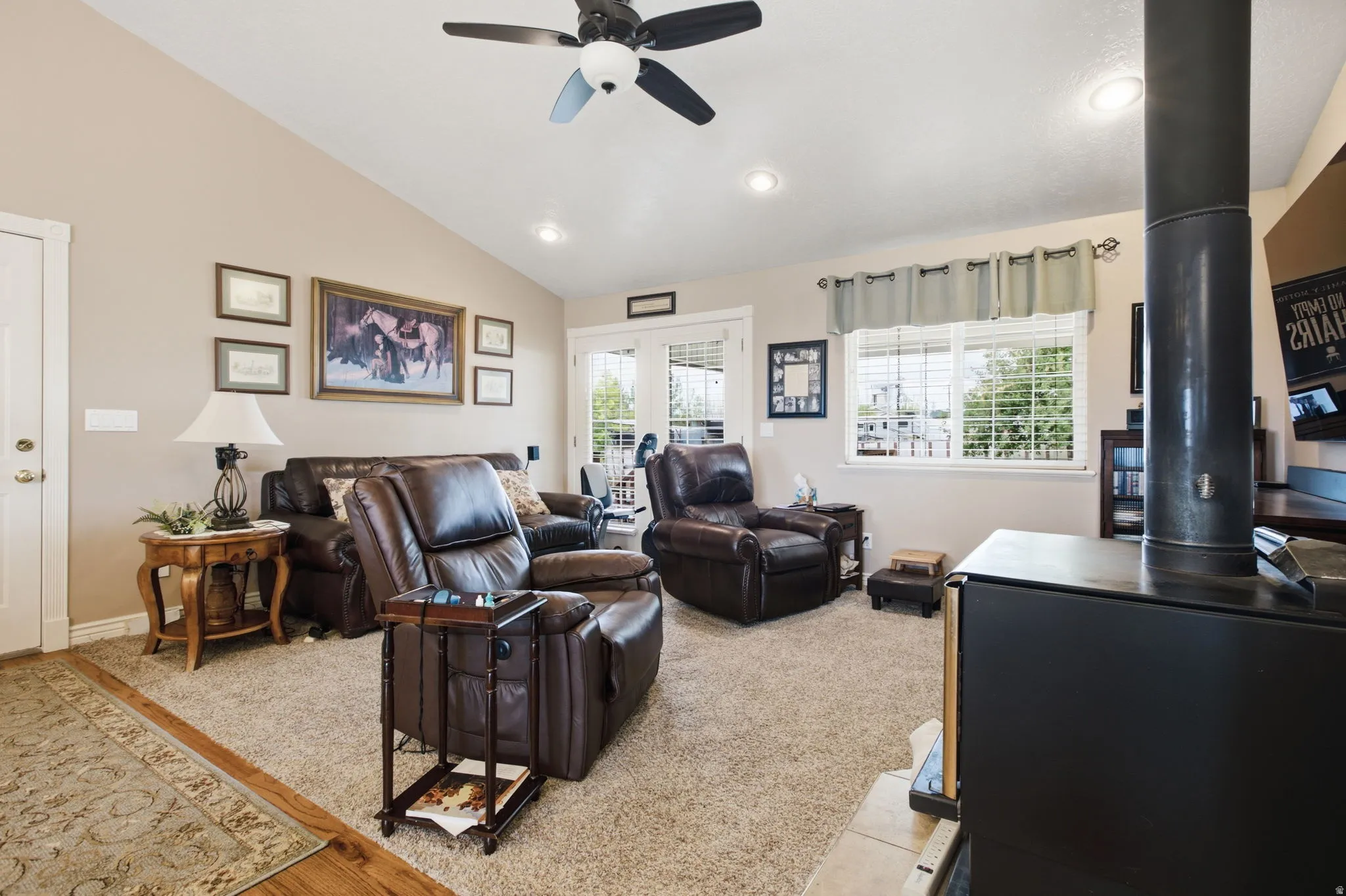 Living area featuring vaulted ceilings, recessed lighting, and a ceiling fan