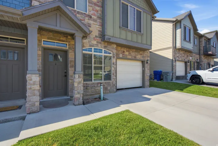 Stone veneer and siding exterior with an arched transom window and a covered entry porch