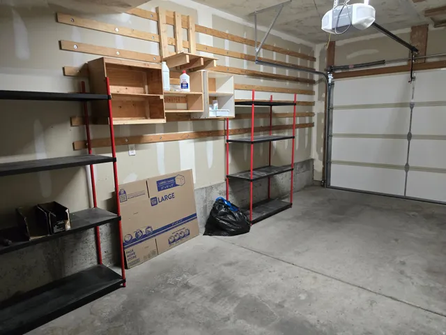 Attached garage featuring a concrete floor and a segmented garage door