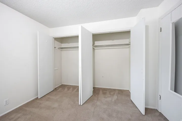 Bedroom featuring neutral carpet flooring and white painted walls