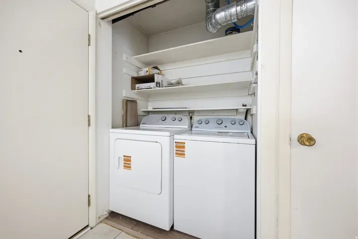 Dedicated laundry area with stacked shelving, providing organization and utility. Brand new washer and dryer.