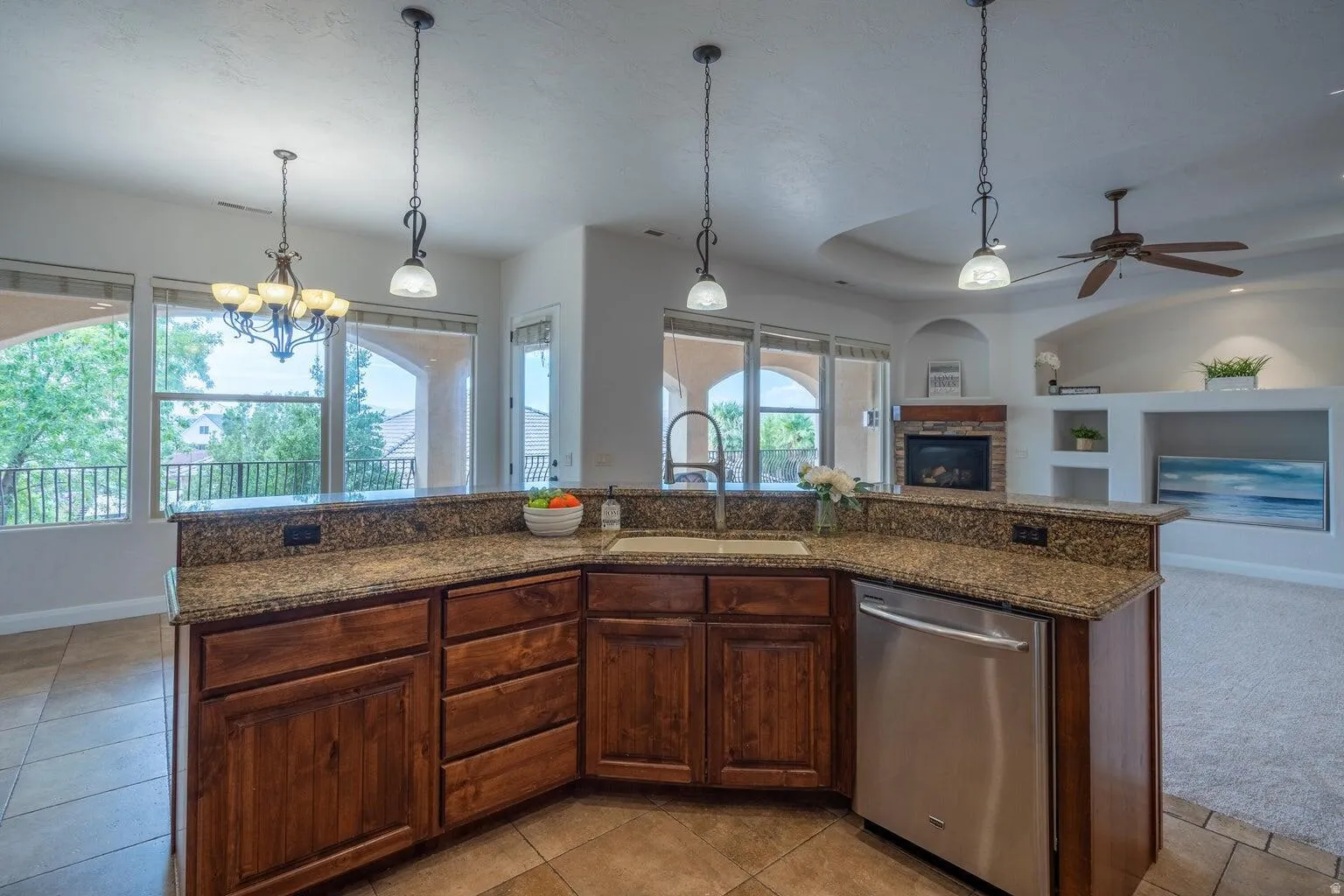 Kitchen featuring wood cabinetry, a stainless steel dishwasher, and a double-basin sink
