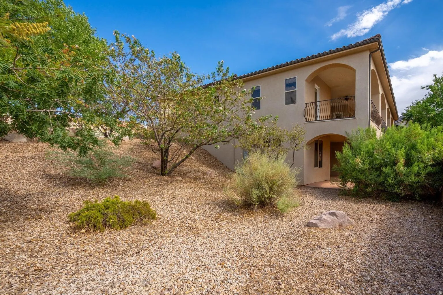 Stucco exterior with a tiled roof and arched details