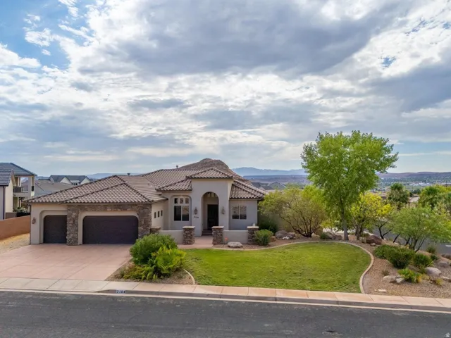 Stucco exterior with stone accents and a terracotta tile roof
