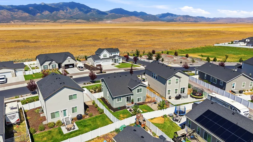 Residential development featuring single-family homes with dark roofs and light-colored siding