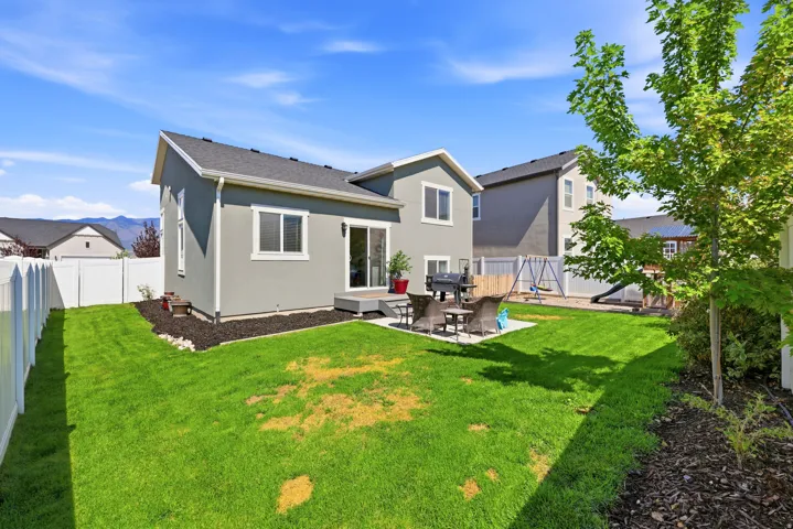 The property features a stucco exterior with a gray finish and white trim