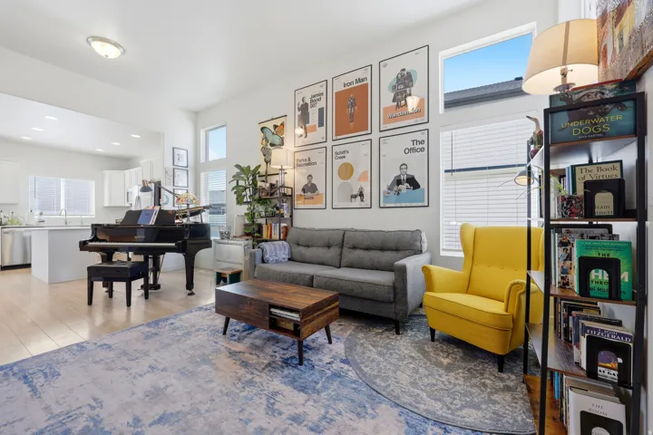 Open-concept living space featuring wood-finish flooring and high ceilings