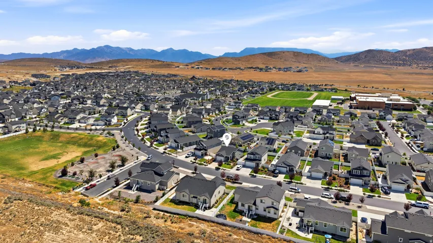 Expansive aerial view showcasing a residential community with numerous single-family homes