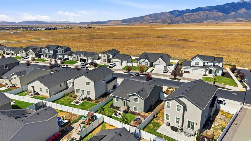 Modern residential development featuring a structured street layout, uniform architectural styles, and individual fenced yards