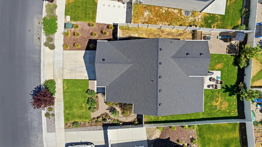 Expansive residential property featuring a dark-toned asphalt shingle roof