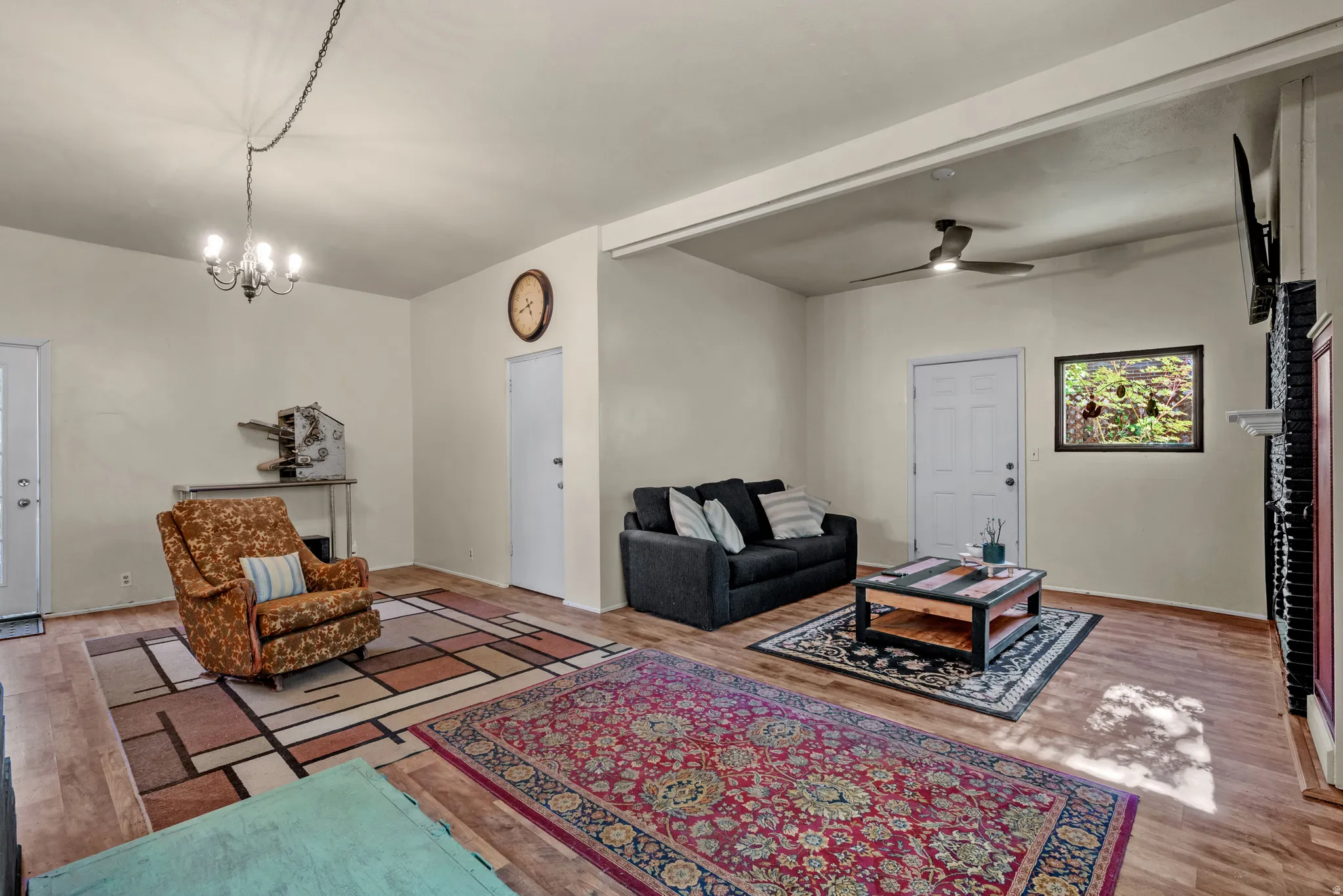 Spacious interior room featuring wood-finish flooring
