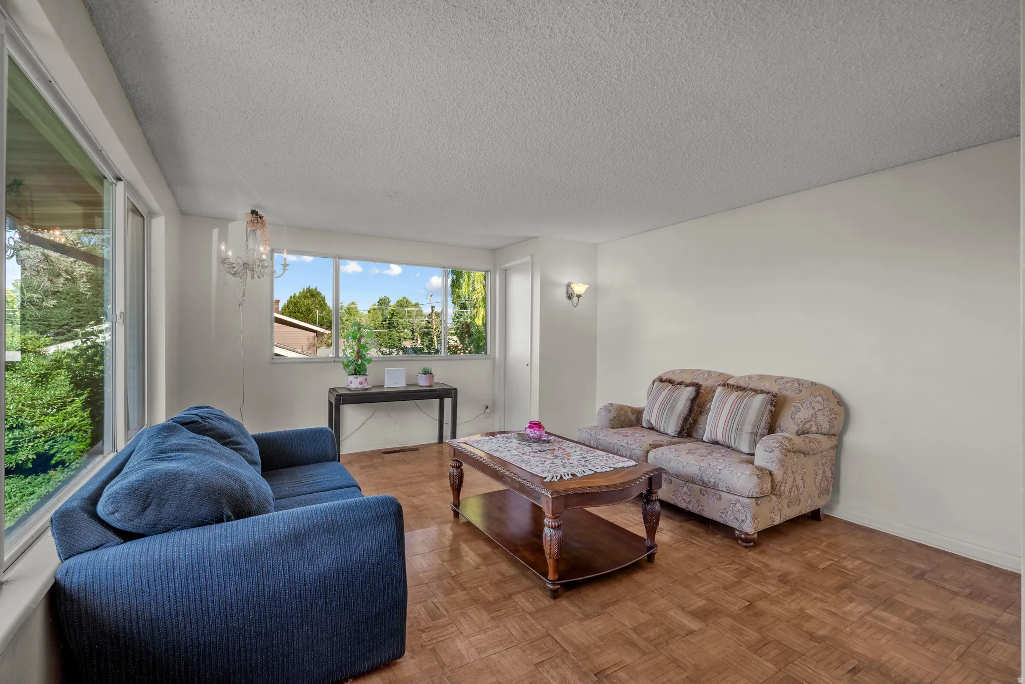 Parquet wood-finish flooring complements abundant natural light from multiple windows