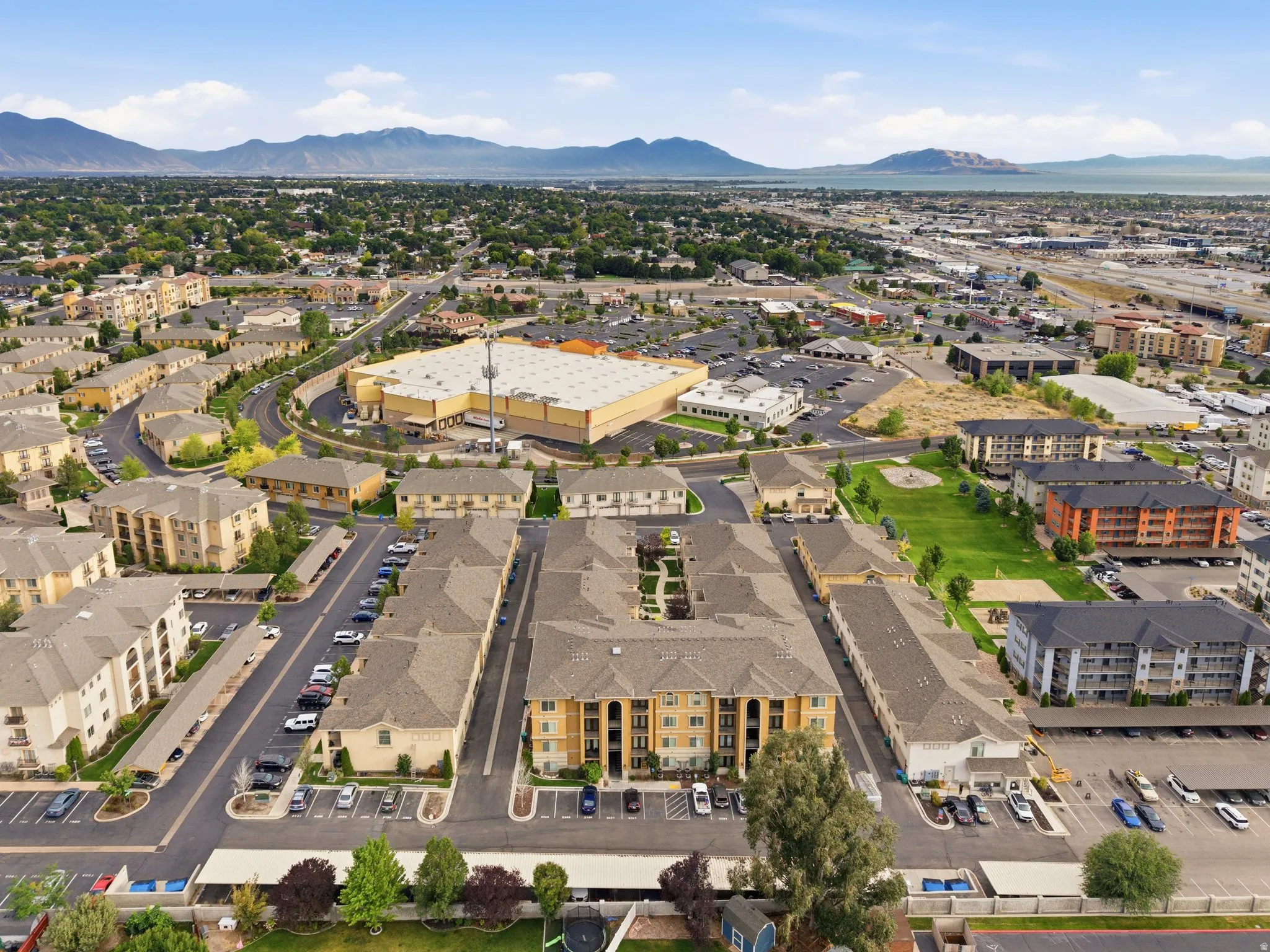 Aerial perspective of a multi-building residential complex featuring pitched roofs and stucco exteriors