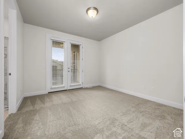 Carpeted interior space featuring white walls and white trim