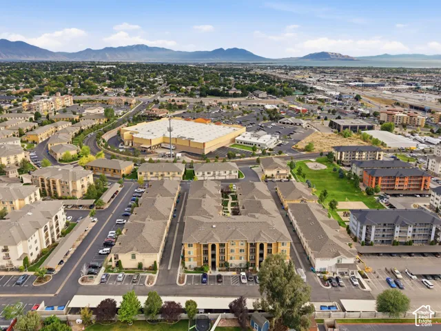 Aerial perspective of a multi-building residential complex featuring pitched roofs and stucco exteriors