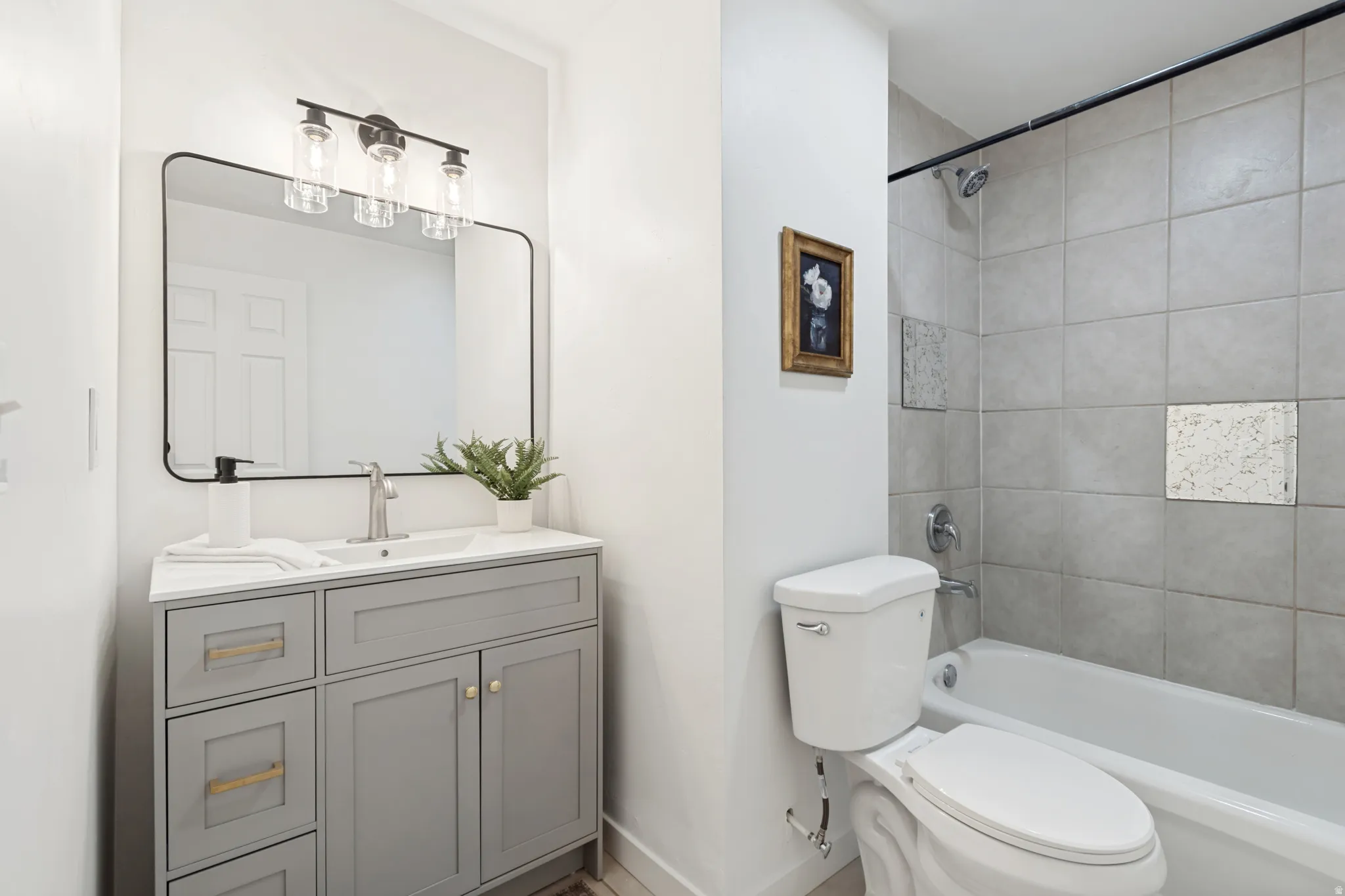 Bathroom featuring a modern vanity with a rectangular sink, satin nickel faucet, and a large framed mirror