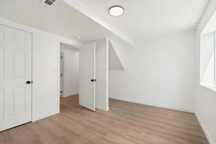Bright room featuring wood-finish flooring and white baseboards