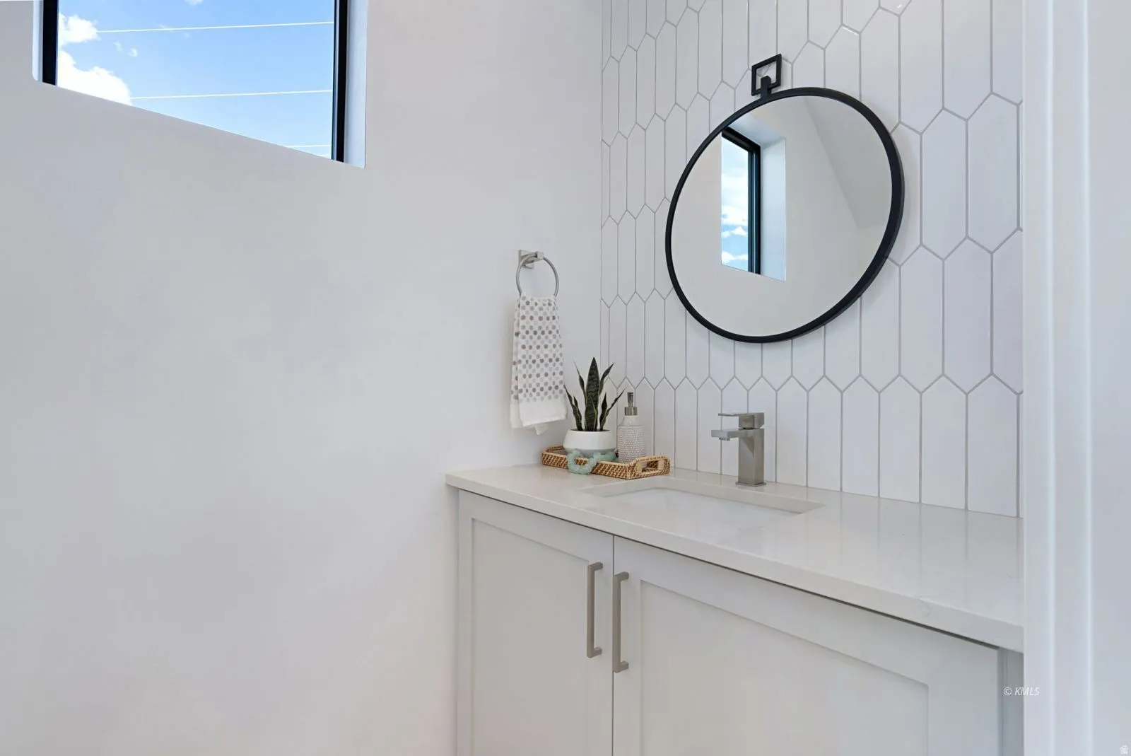 White single vanity with shaker-style cabinetry and brushed nickel hardware