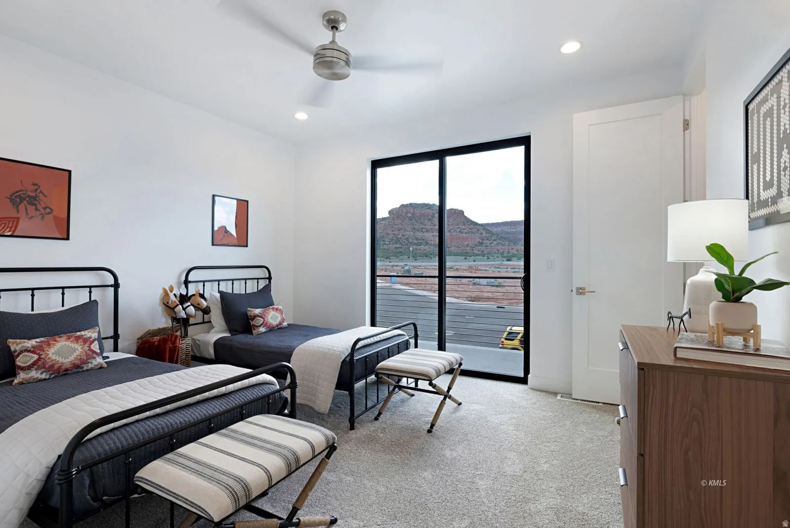 Spacious room featuring a full-light sliding door, neutral carpeting, recessed lighting, and a ceiling fan