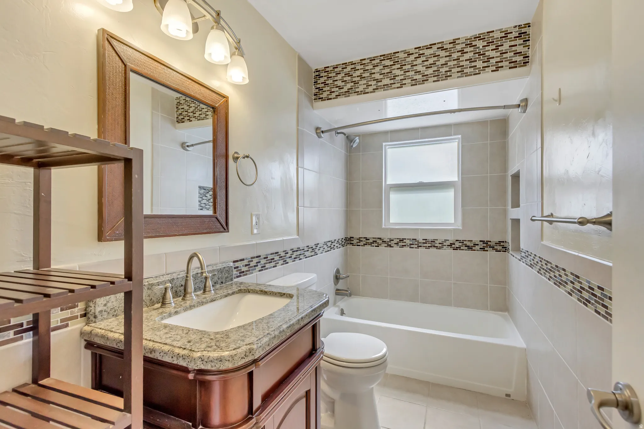 Bathroom featuring a single vanity with granite countertop and undermount sink