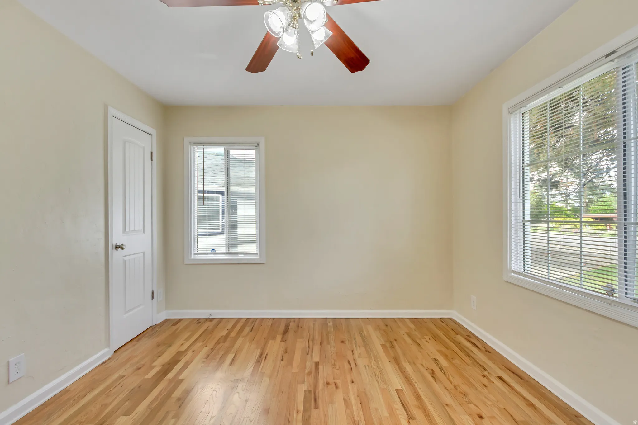 Light-filled interior space featuring wood-finish flooring, neutral wall tones, and white trim