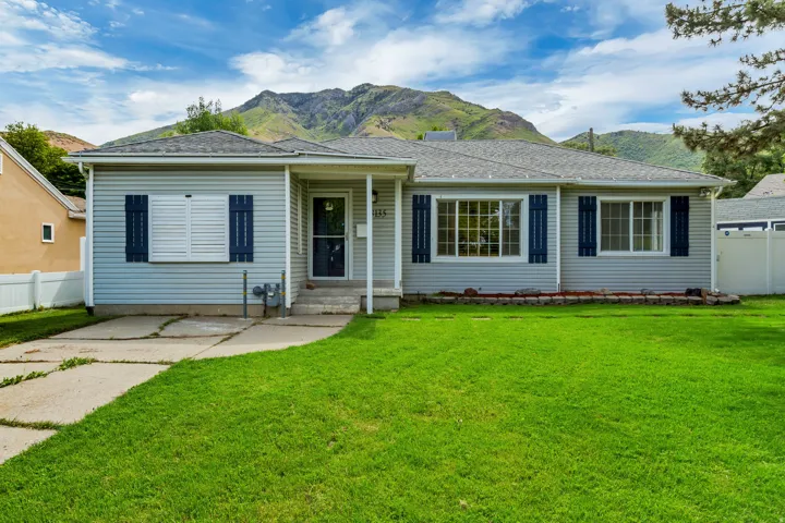 Light blue siding exterior with dark blue decorative shutters