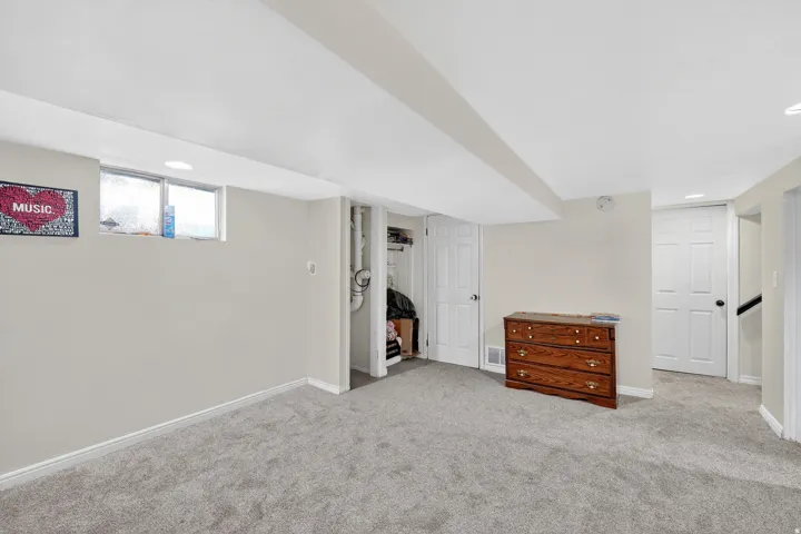 Carpeted room featuring light-colored walls and white trim