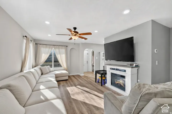 Living area featuring wood-finish flooring, recessed lighting, and a ceiling fan