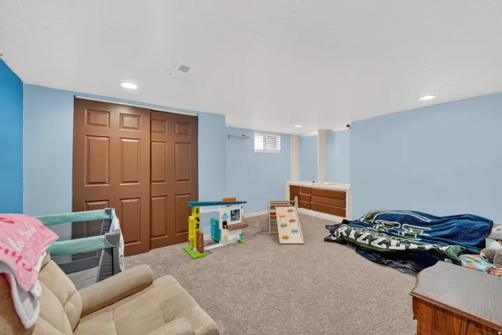 Spacious room with light blue walls and neutral carpet flooring