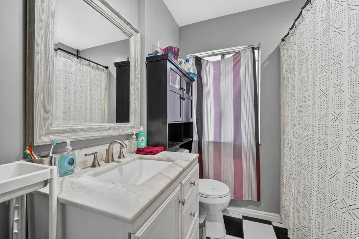 Bathroom featuring a white vanity with an undermount sink and a light-colored countertop