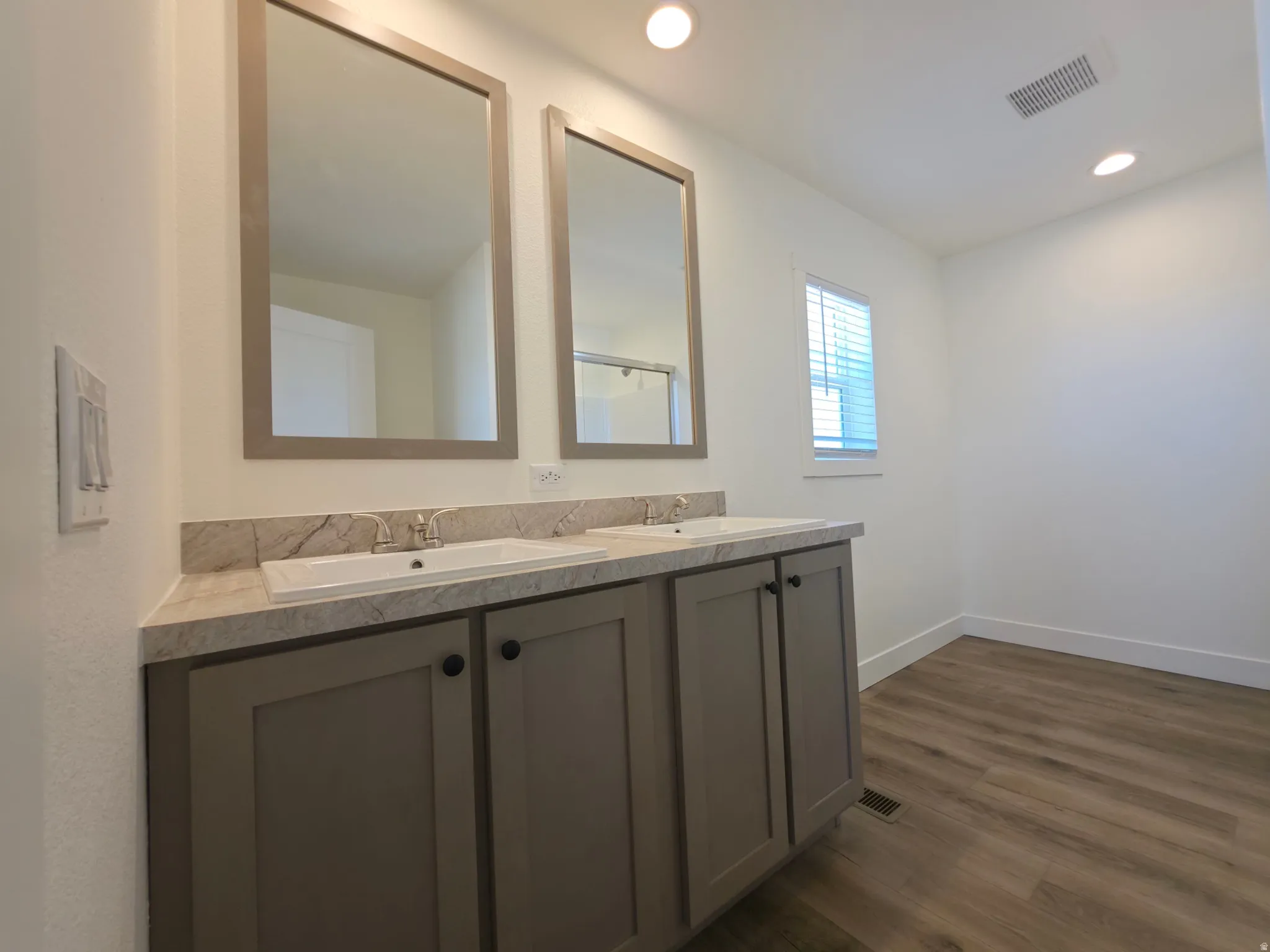 Dual vanity with integrated sinks and a light-toned countertop