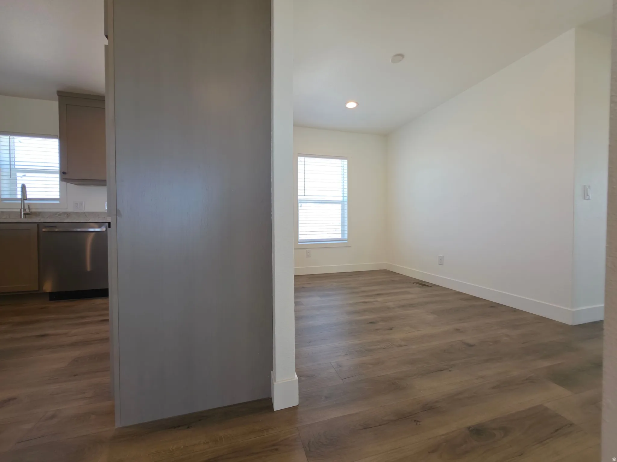 Bright interior space featuring wood-finish flooring, recessed lighting, and white baseboards