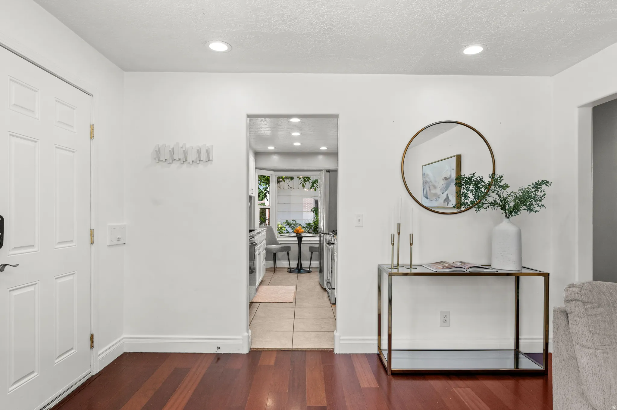 Entryway featuring wood-finish flooring and white paneled door
