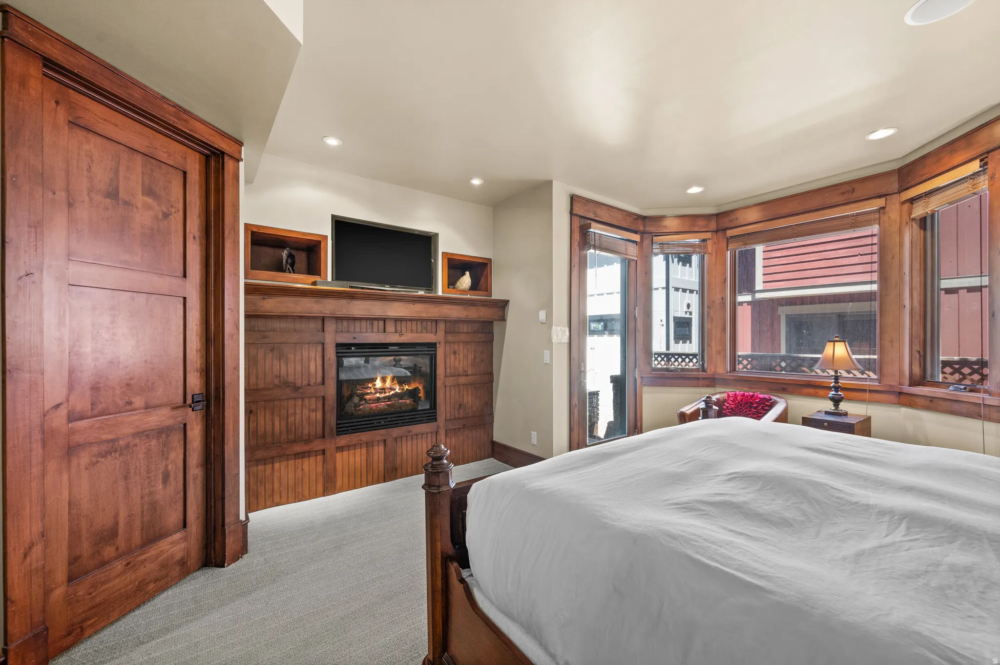 Built-in media center with a gas fireplace, wood-finish paneling, and integrated display shelving