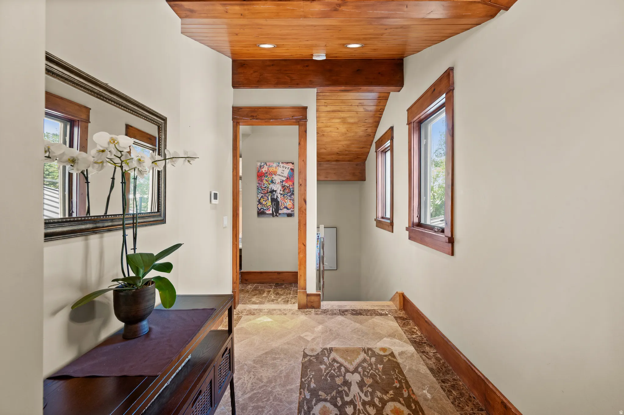 Hallway featuring wood-finish ceiling and exposed beams