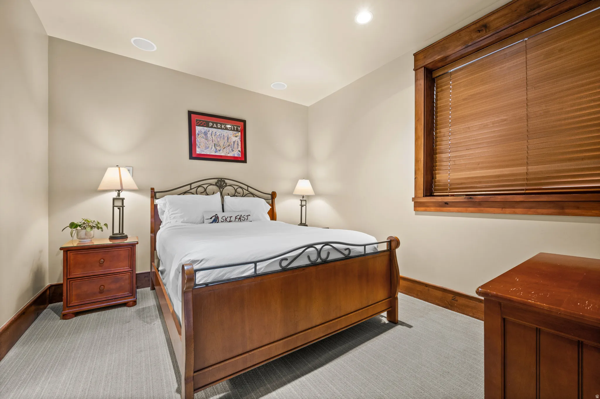 Bedroom featuring light-colored walls and patterned carpeting