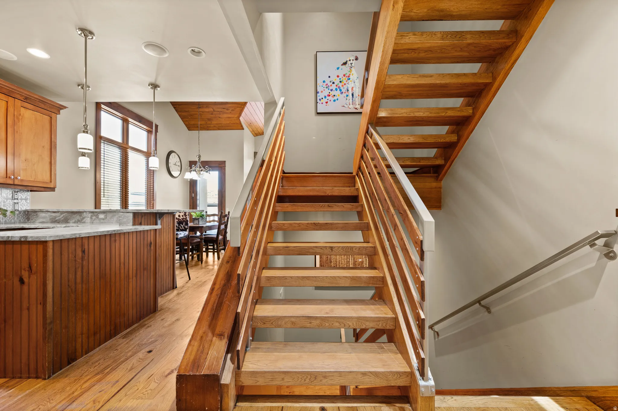Open-tread wood staircase with horizontal slat railing