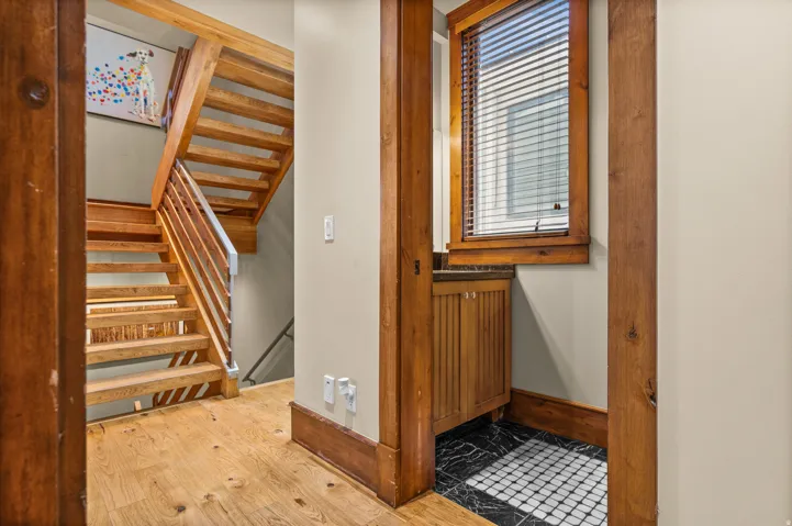 Hardwood staircase featuring wood treads and metal balusters