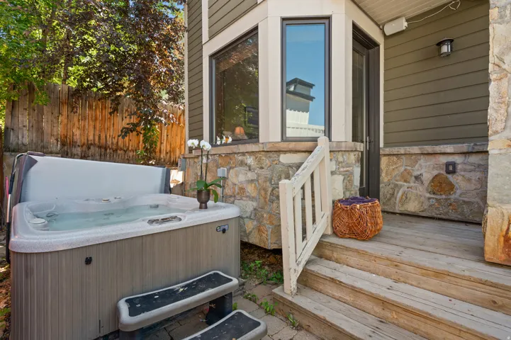 Outdoor spa area featuring a built-in hot tub with steps