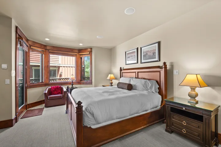 Carpeted room featuring a bay window, recessed lighting, and wood trim details