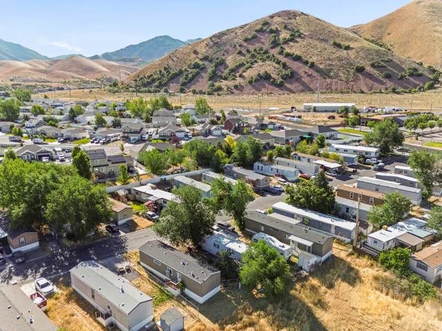 Community with varied housing types, surrounded by natural mountainous terrain