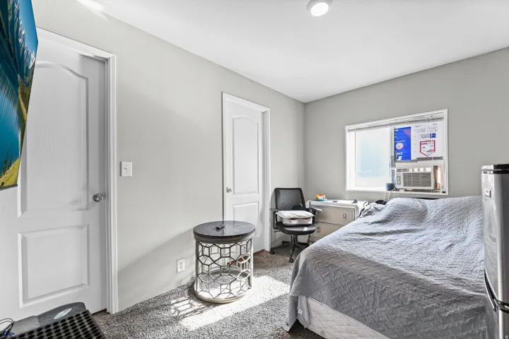 Room featuring light grey painted walls and a window with blinds