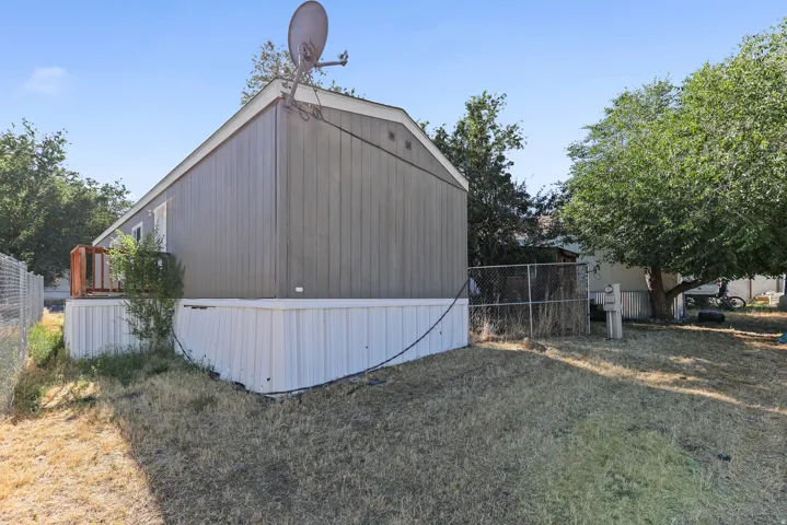 Gray siding exterior with white skirting