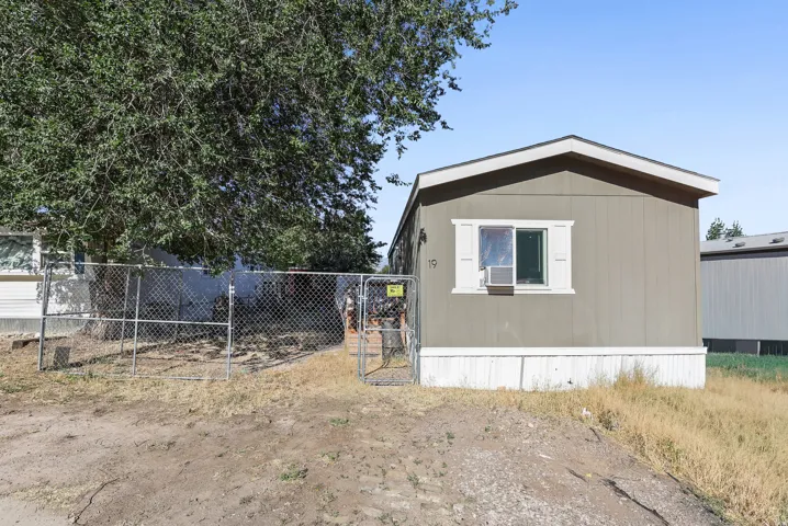 Single-story structure featuring horizontal siding and white trim