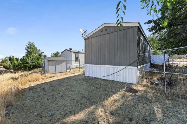 Exterior featuring gray siding and white skirting
