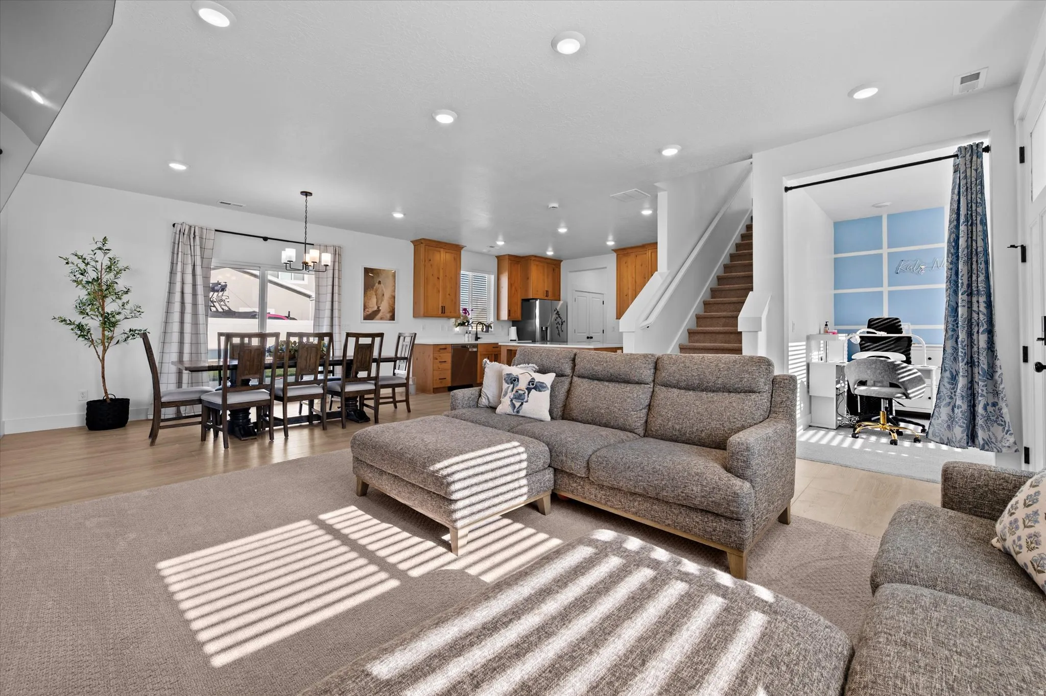 Open-concept living area with recessed lighting, wood-finish flooring, and a dedicated office space