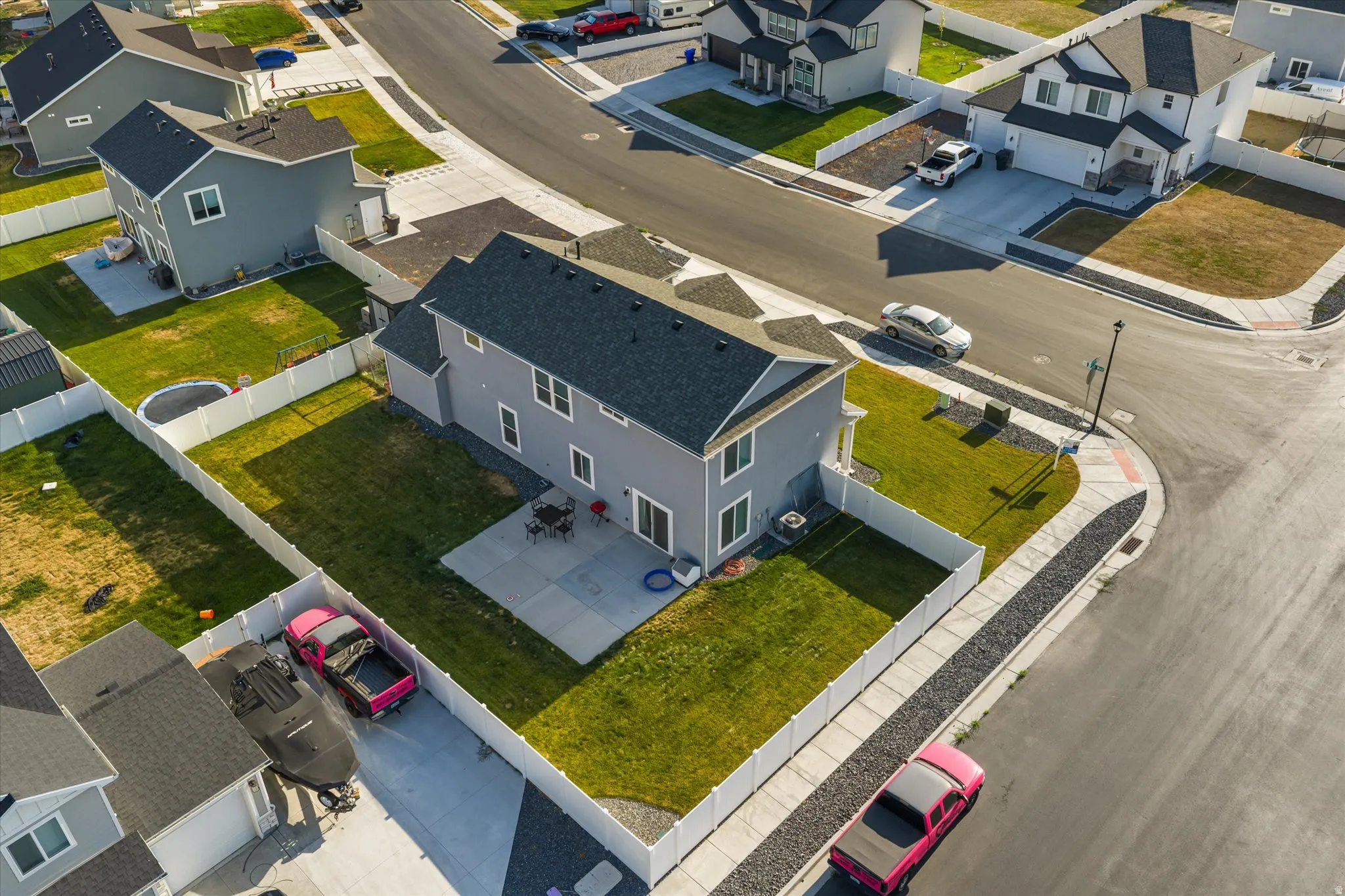 Two-story residence with a dark shingle roof and light gray siding
